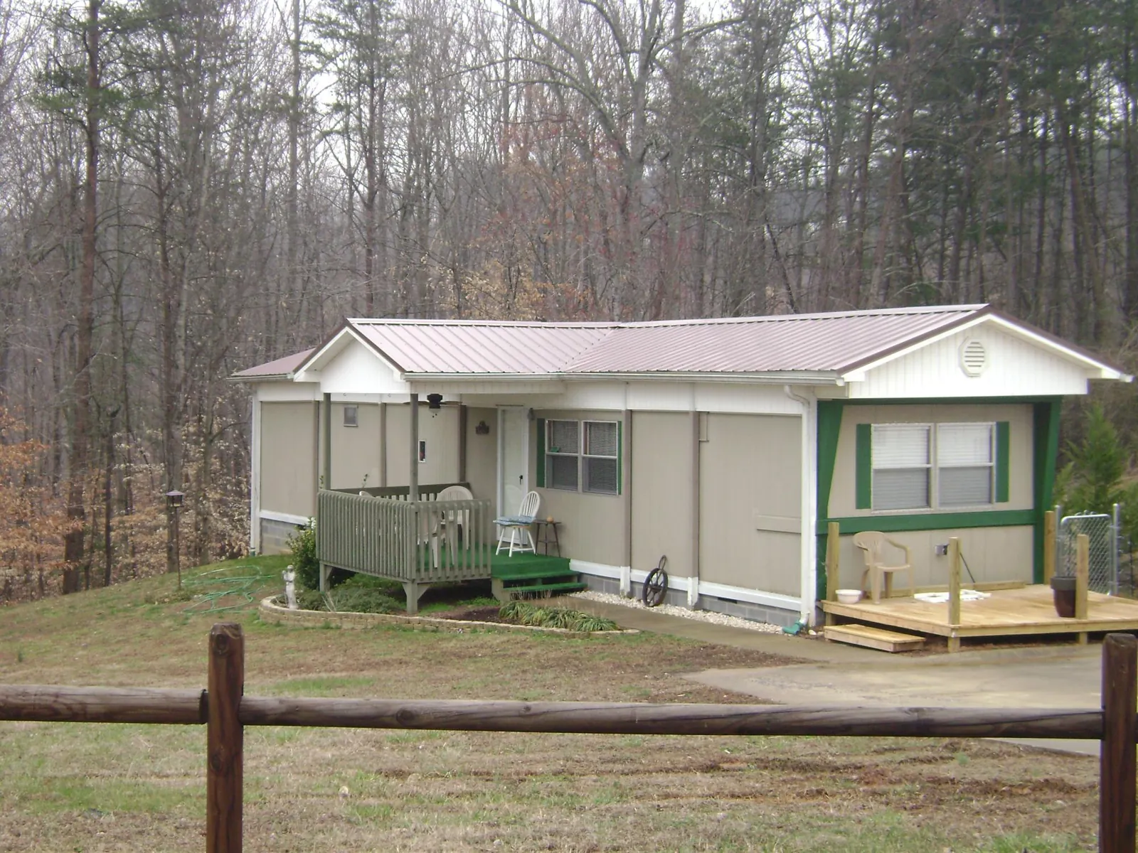 Mauve metal roof on a manufactured home with a new front deck in Furlong